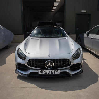 Front view of a Mercedes-Benz vehicle highlighting its sharp headlight design