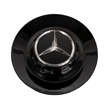 Close-up of Mercedes AMG wheel centre caps with chrome AMG logo